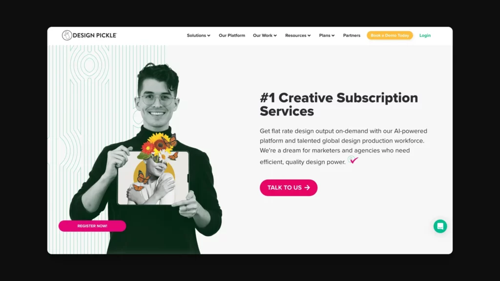 A person holds a picture with a floral design over their face. Text on the right reads: #1 Creative Subscription Services. Buttons below say Register and Talk to Us. Design Pickle logo in the top left. The background is dark with some lines.